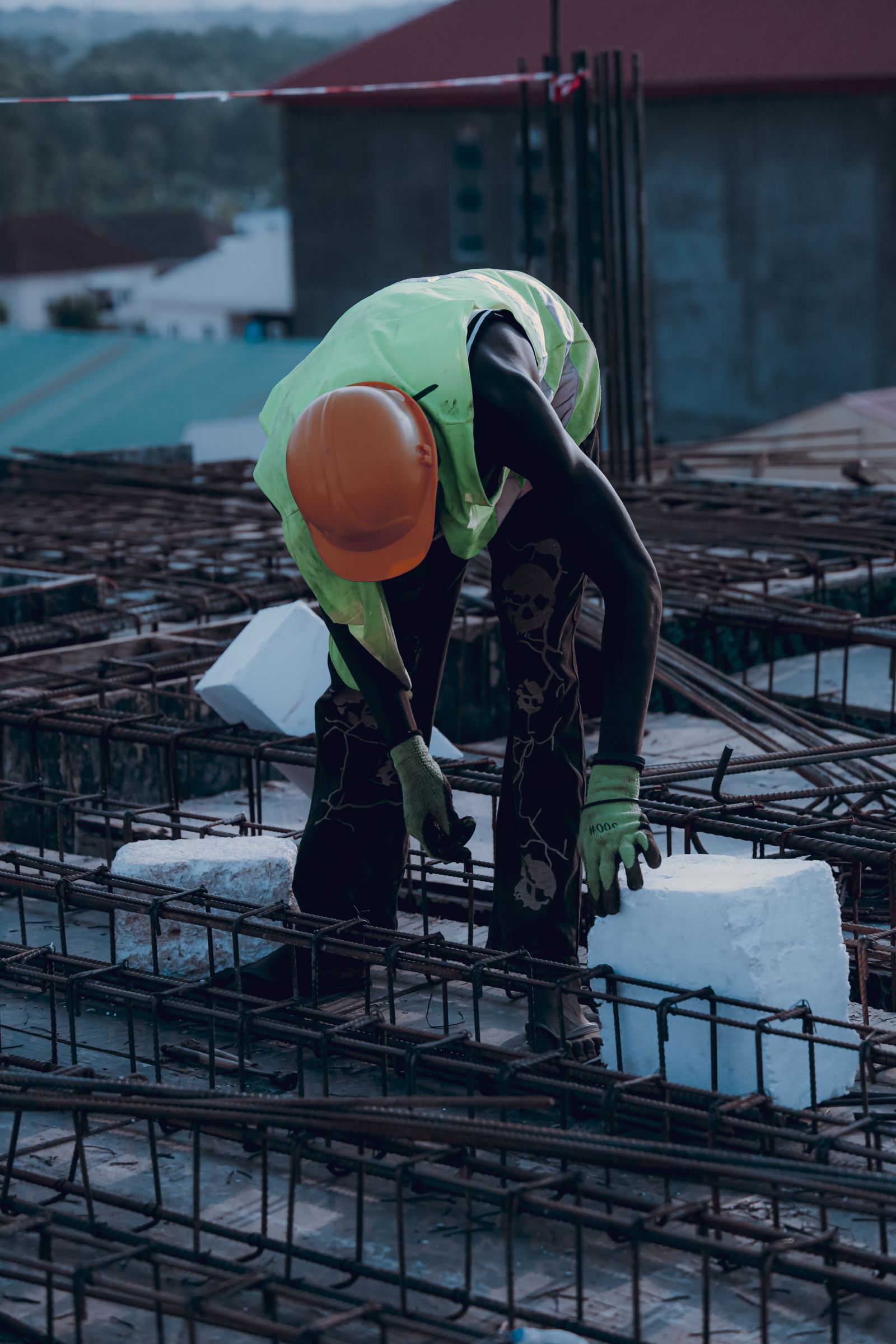 A construction worker placing blocks between steel reinforcement